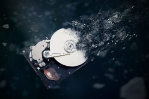 The old hard disk drive is disintegrating in space. Conception of passage of time and obsolete technology - Guardian Data Guardian Data